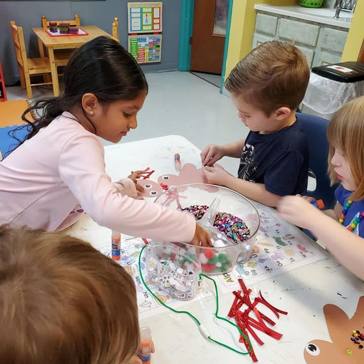 A classroom with tables and chairs and a lot of toys.