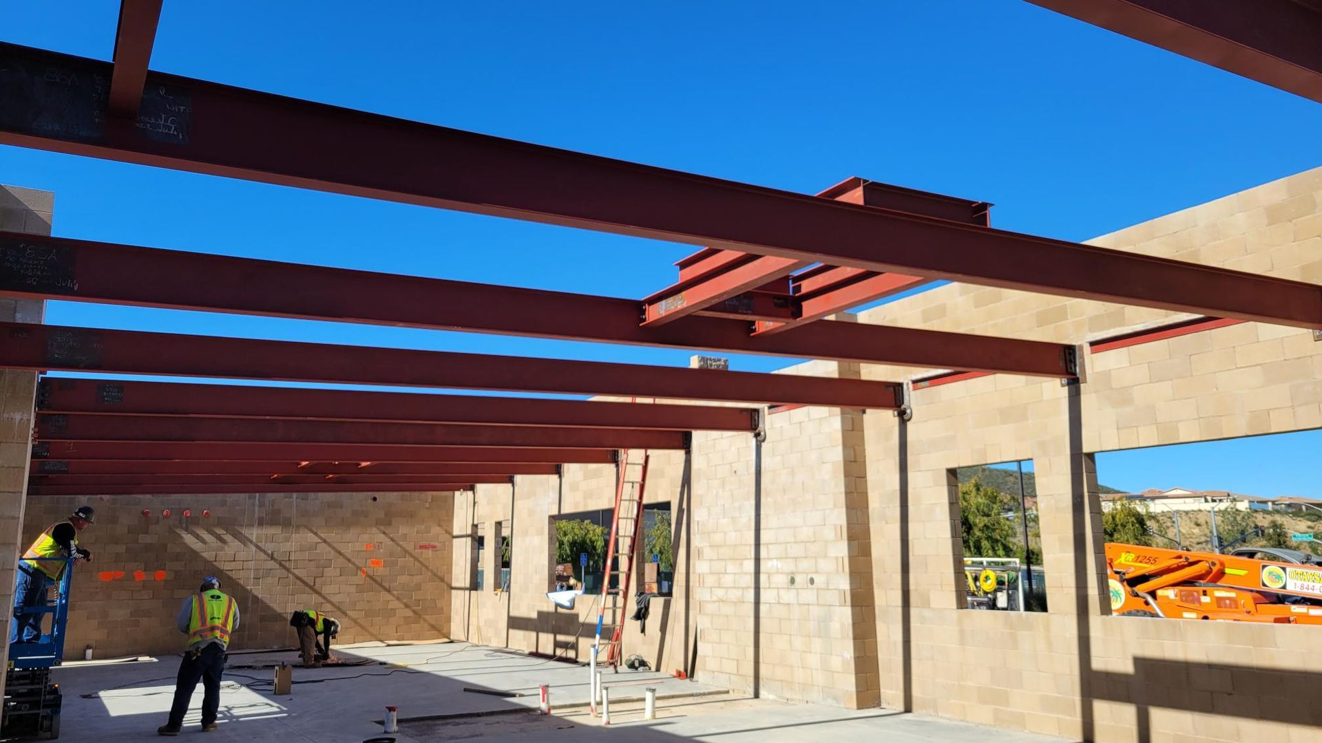 A group of construction workers are working on a building under construction.