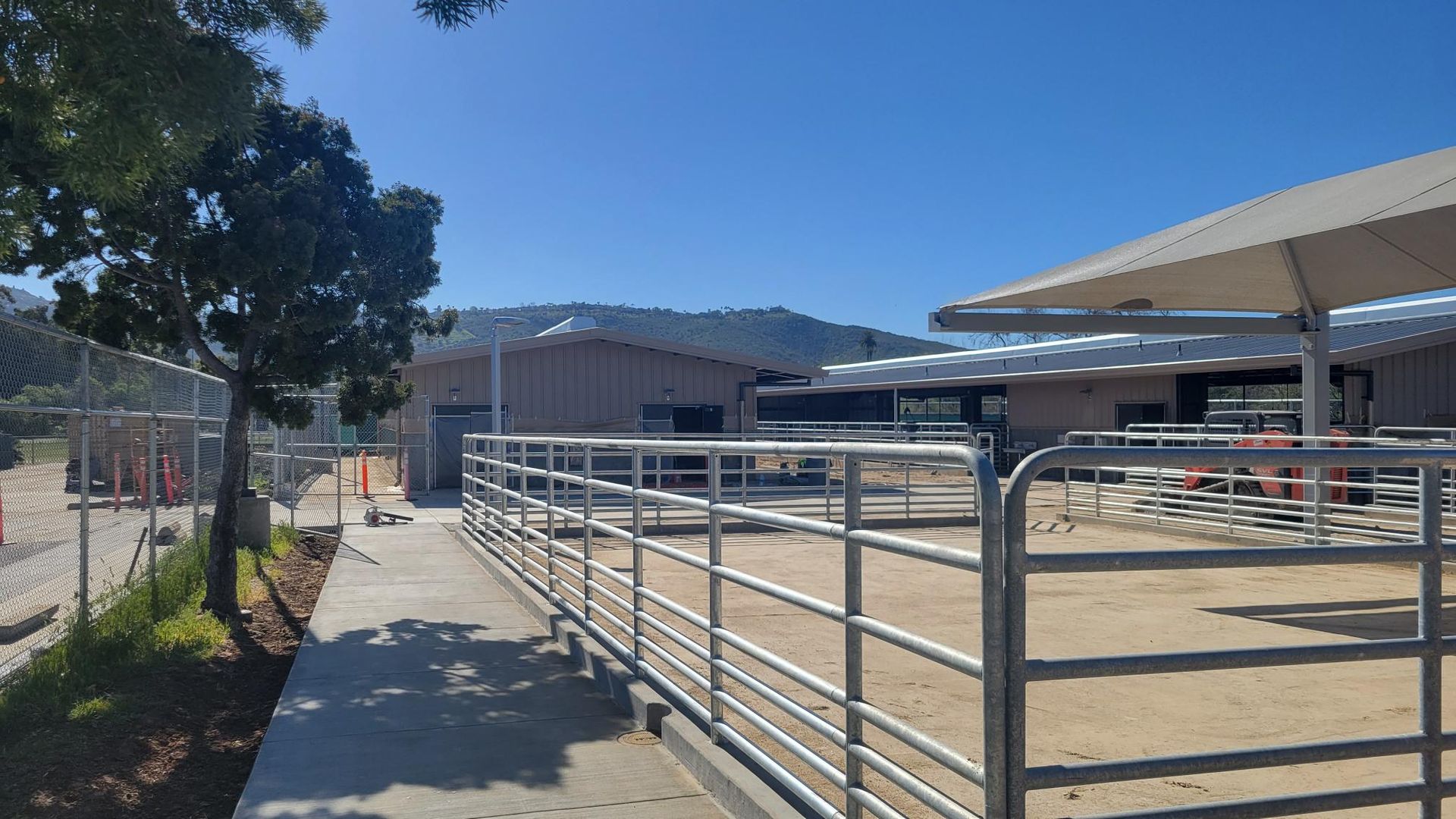 A fenced in area with a building in the background