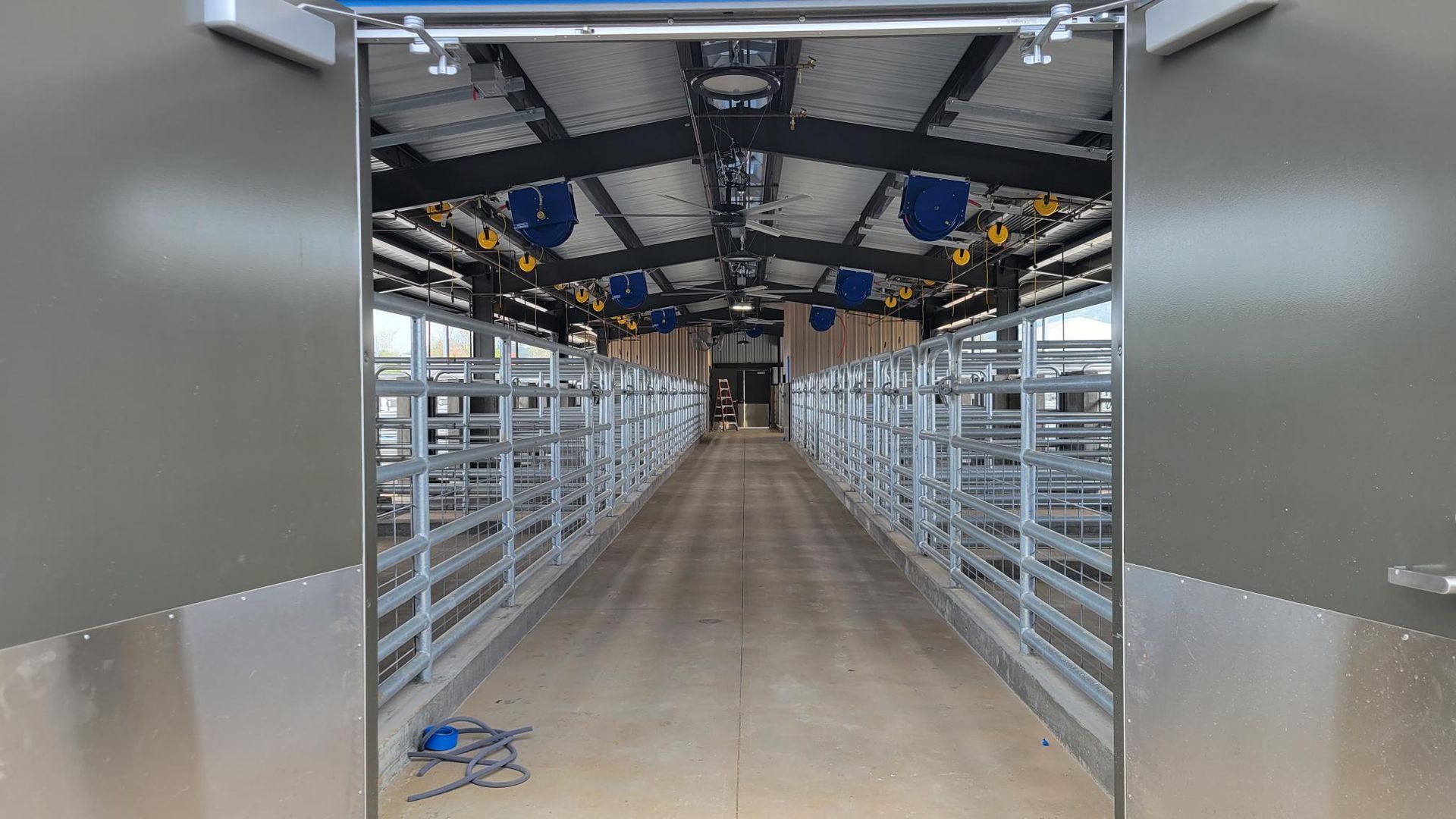 A long hallway in a building with a sliding door open.