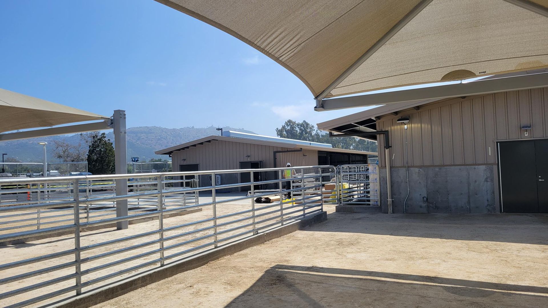 A fenced in area with a few buildings in the background.