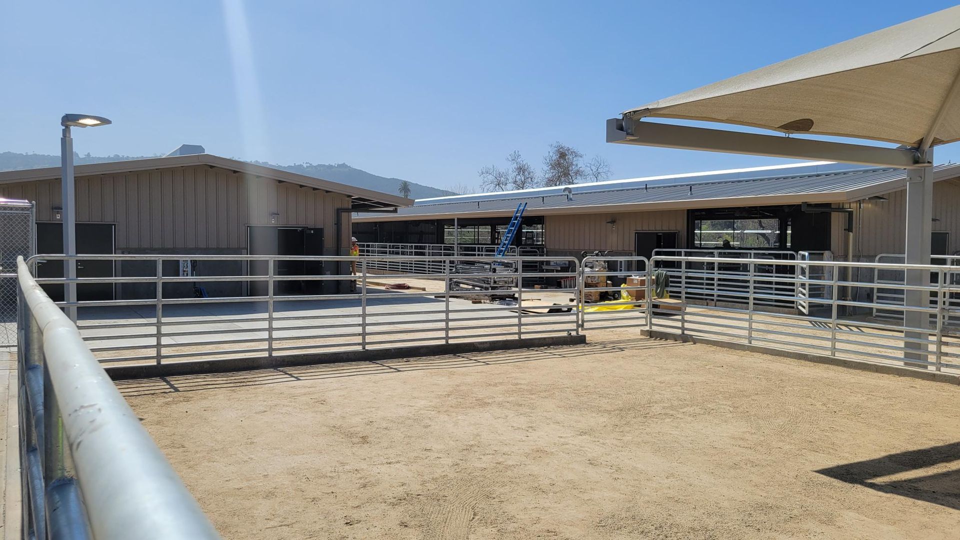 A fenced in area with a lot of buildings in the background