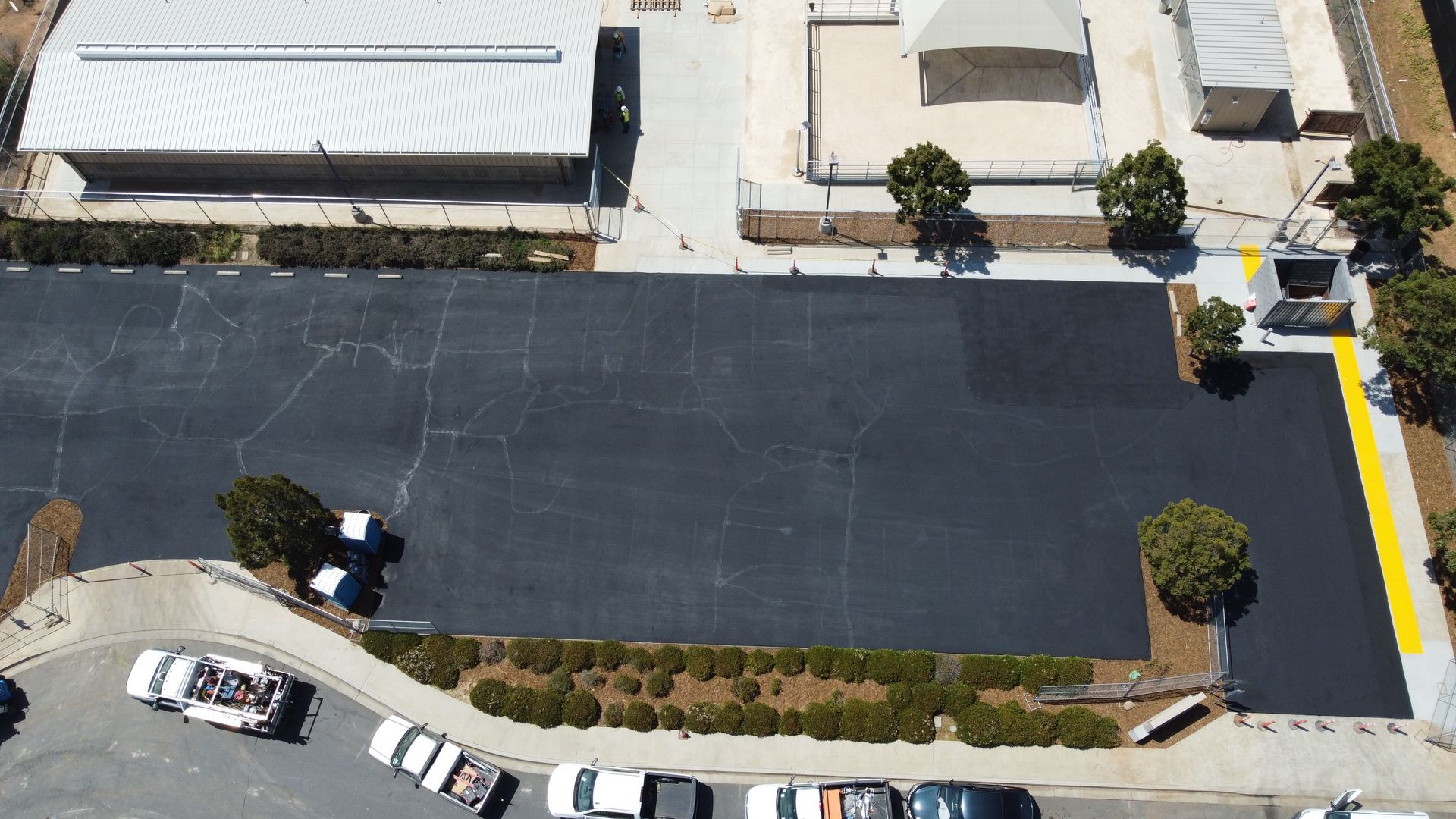 An aerial view of a parking lot in front of a building