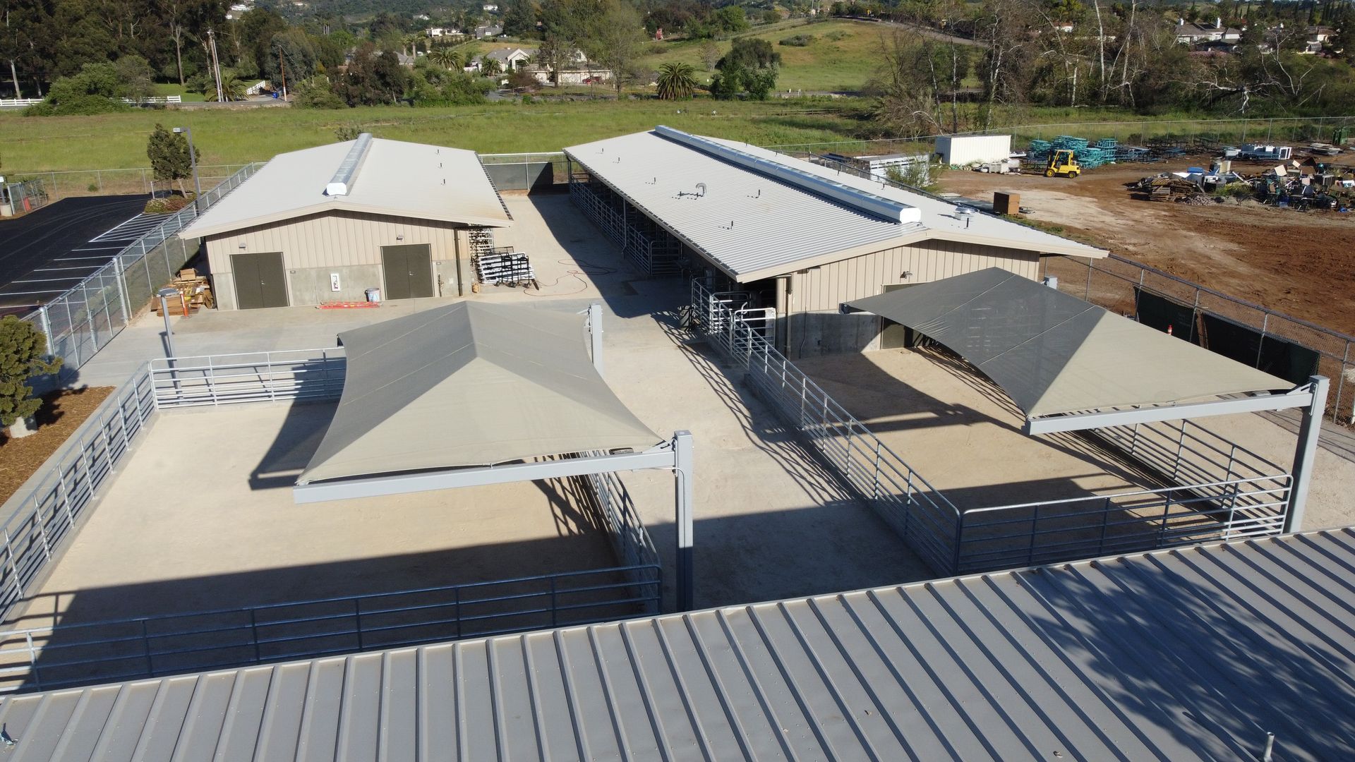 An aerial view of a building with shades on the roof