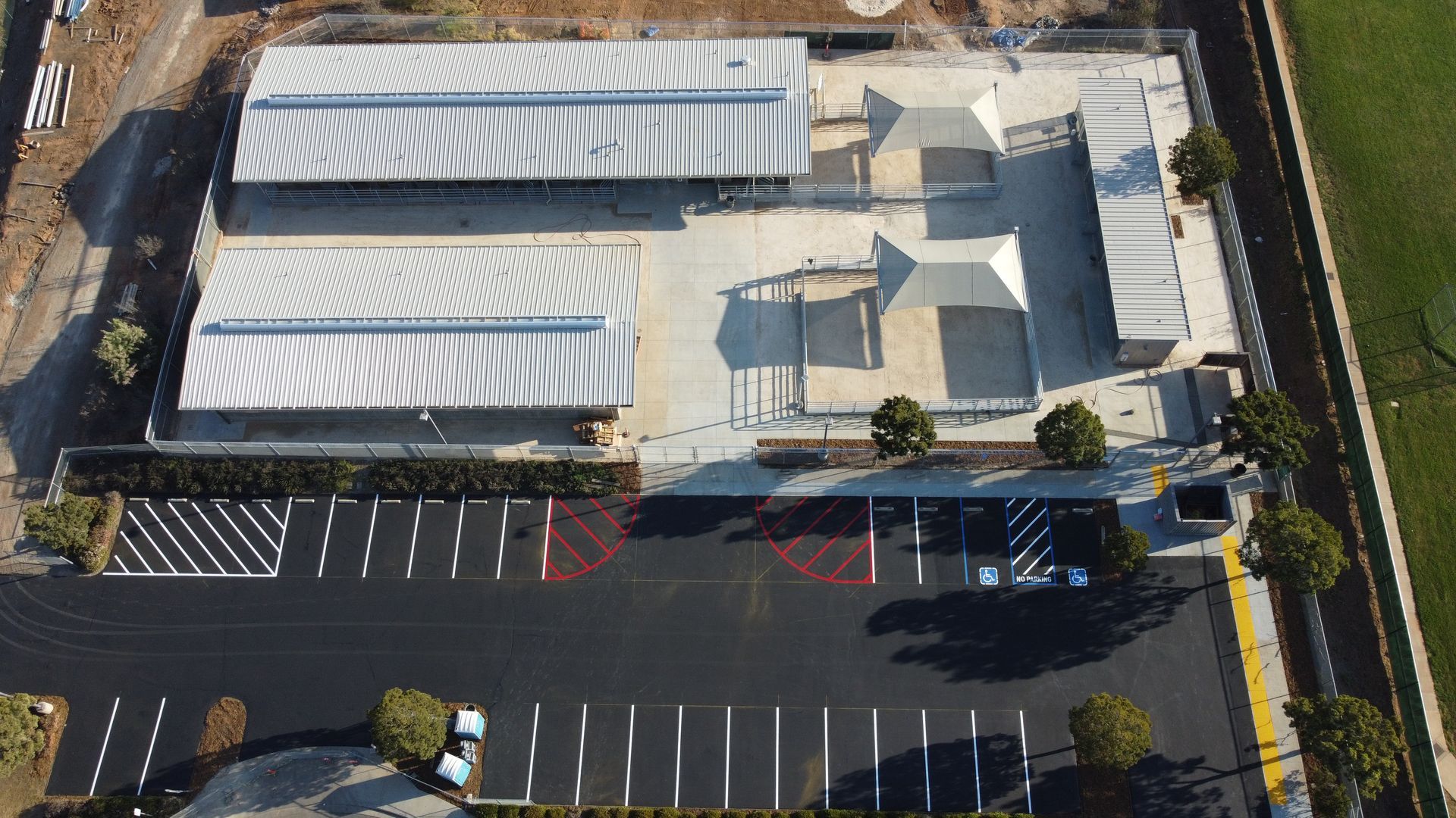 An aerial view of a building with a parking lot in front of it