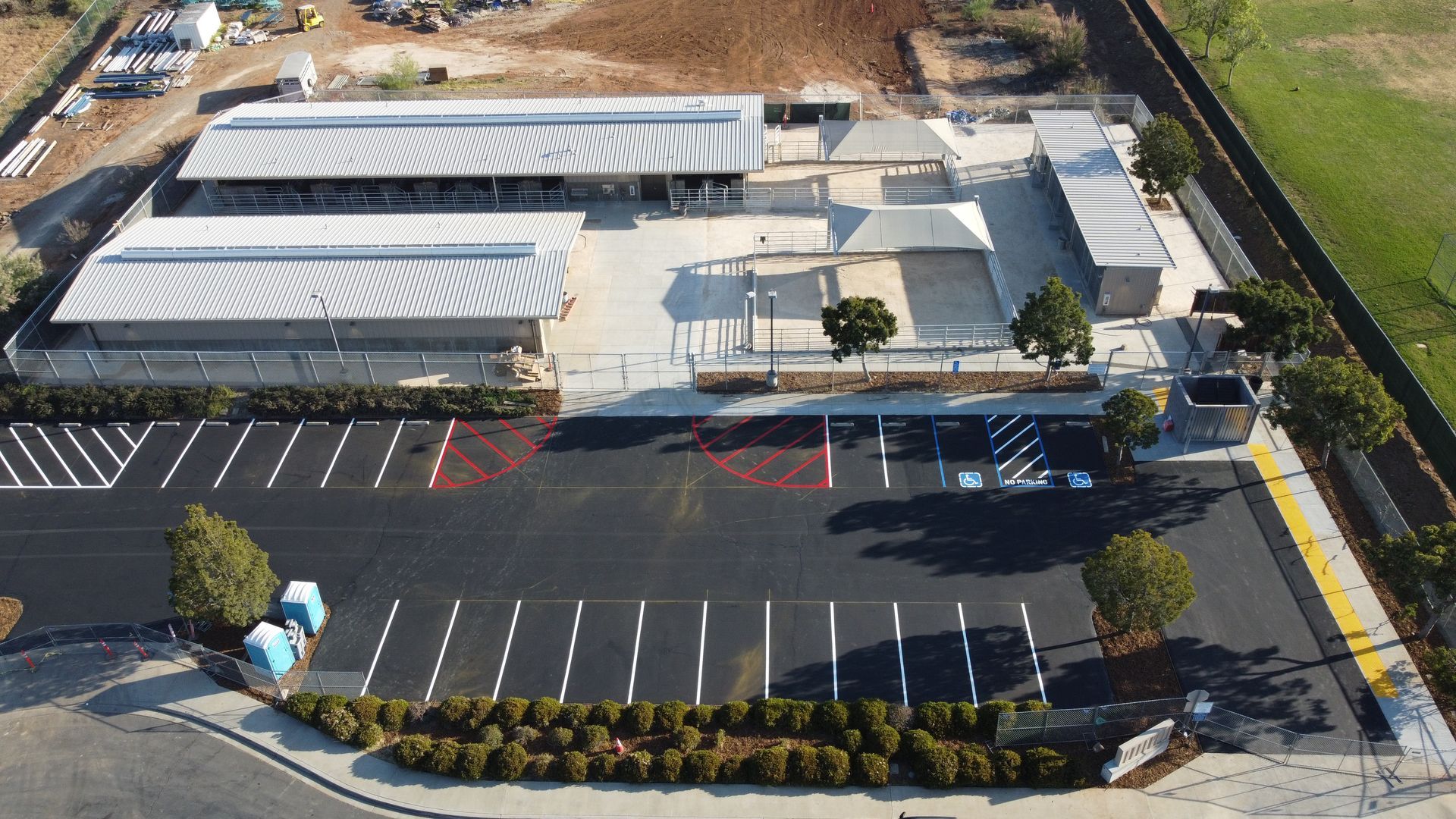 An aerial view of a large building with a parking lot in front of it