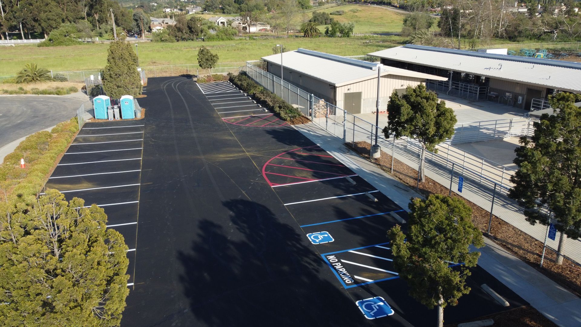 An aerial view of a parking lot in front of a building.