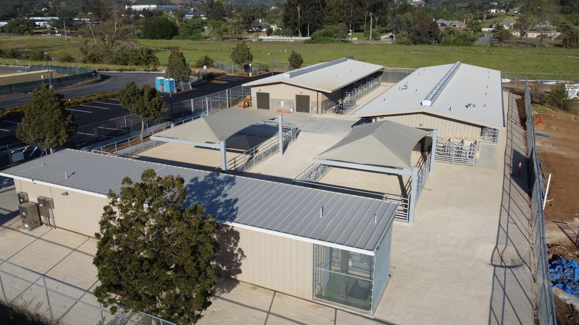An aerial view of a large building with a fence around it