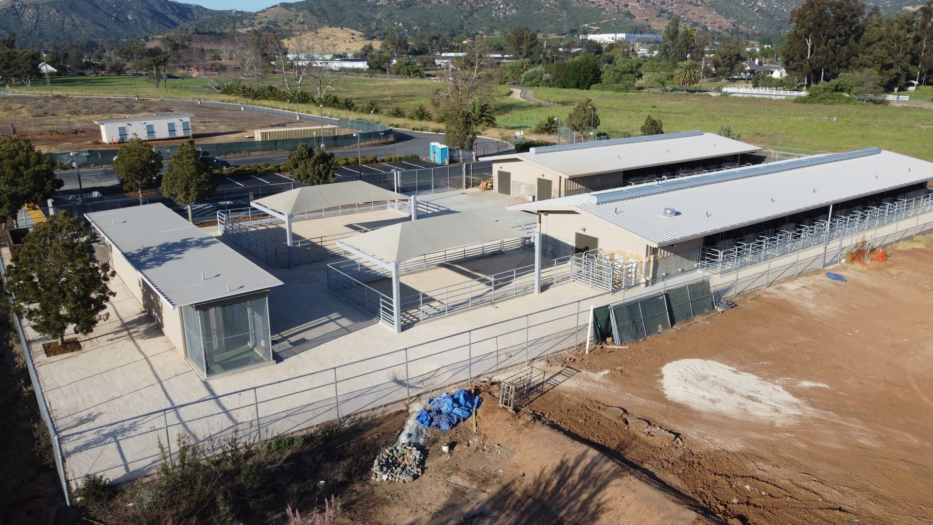 An aerial view of a building under construction with a fence around it.