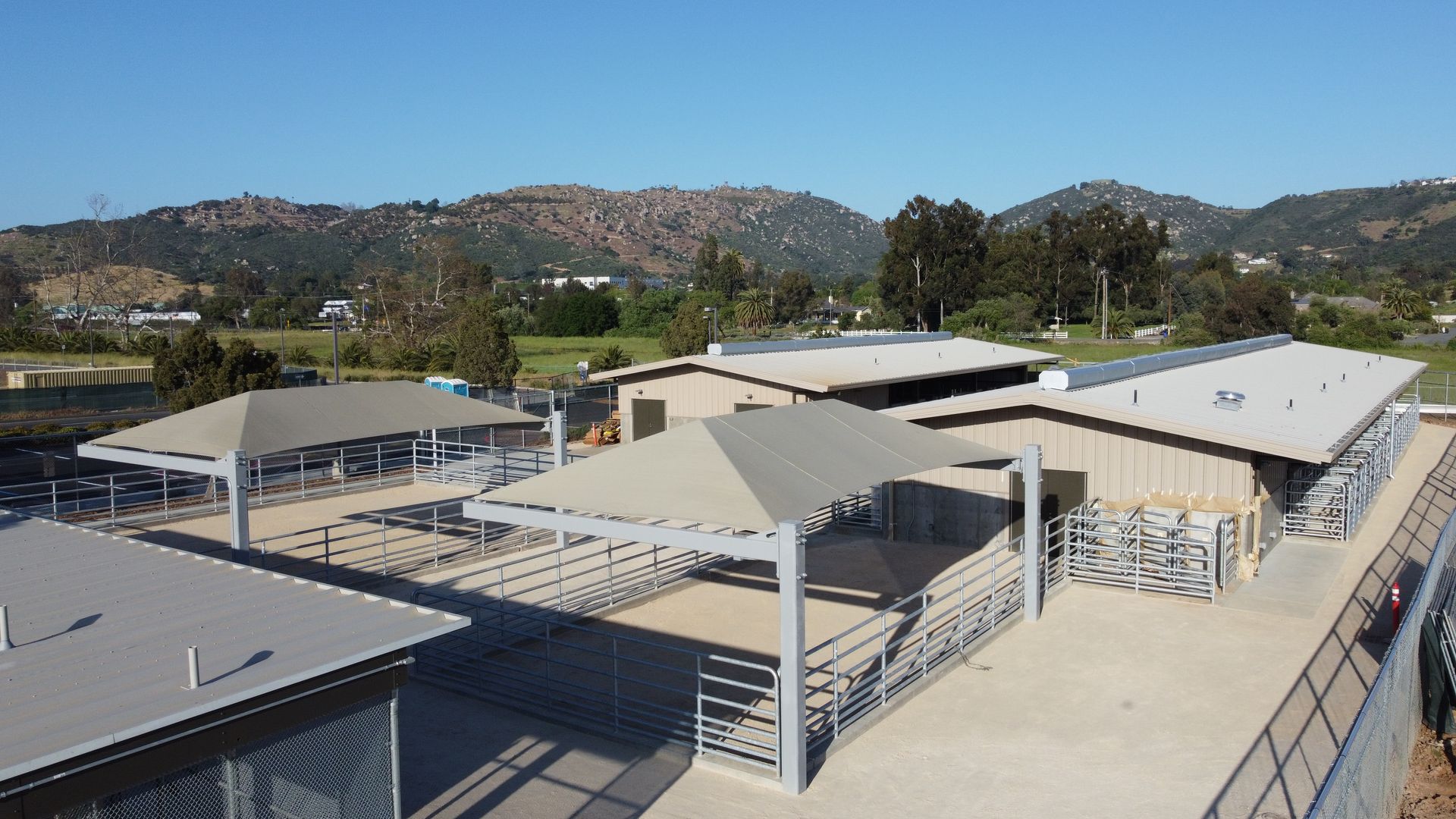 An aerial view of a building with mountains in the background