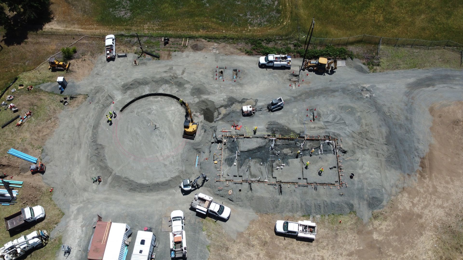 An aerial view of a parking lot with a lot of cars parked in it.