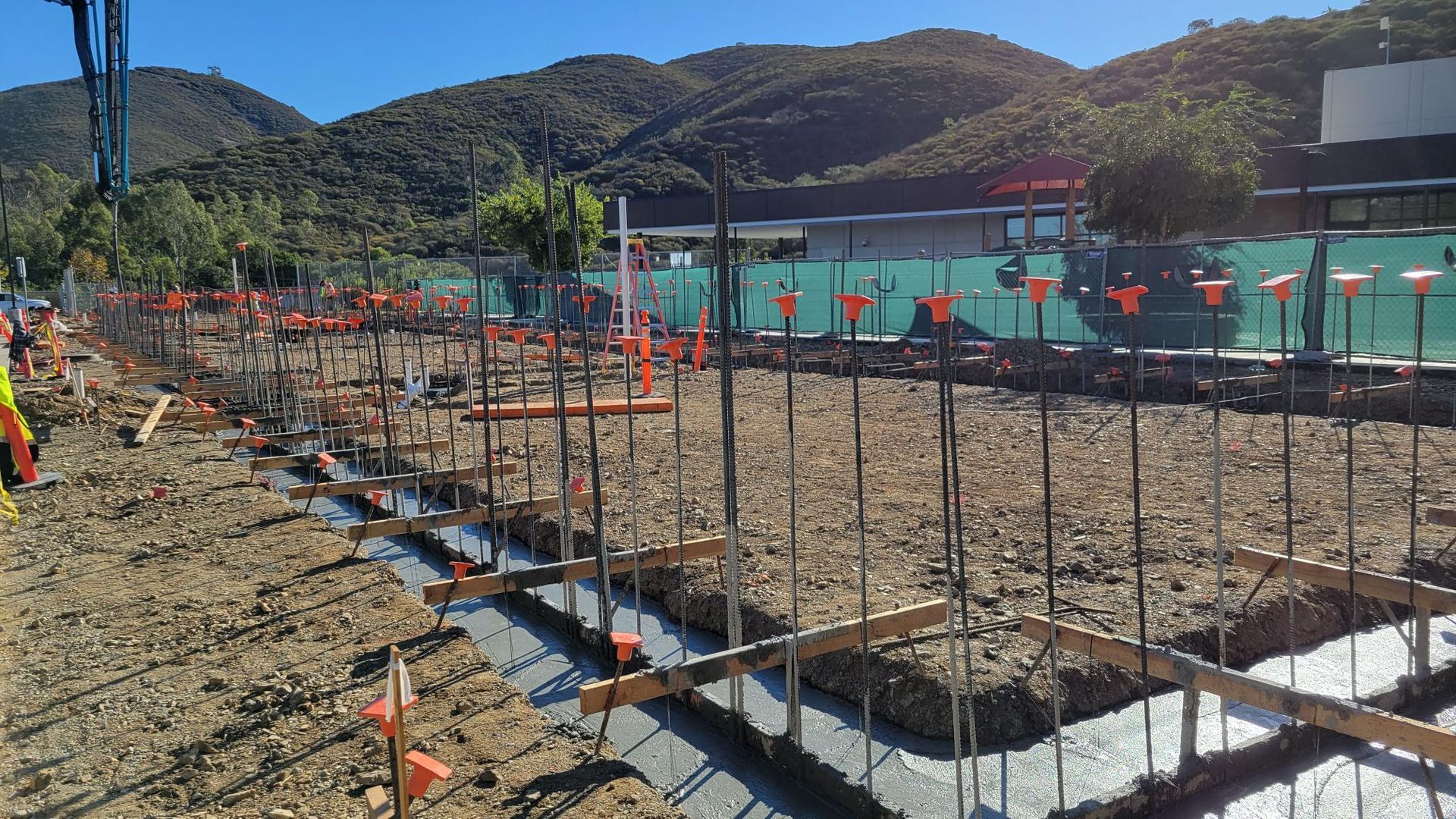 A construction site with a crane in the background.