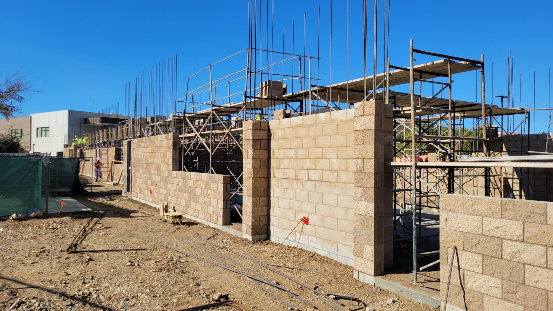 A building is being built with bricks and scaffolding.