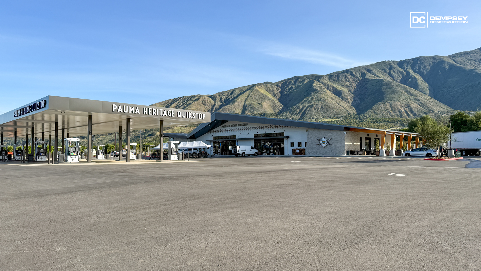 Rendering of a commercial building with a Starbucks, parking lot, and mountains in the background.