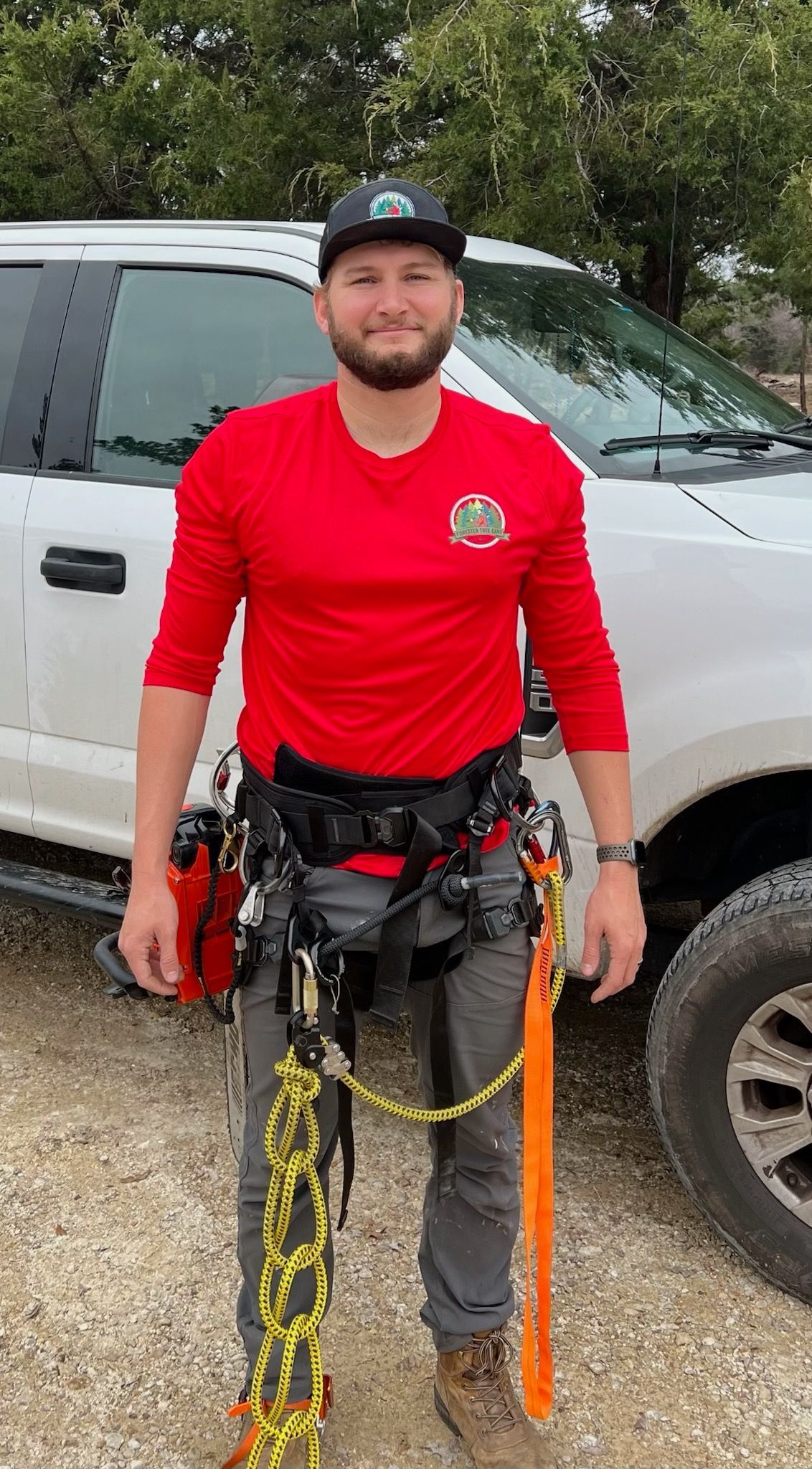 A black dumpster is parked on the side of the road.
