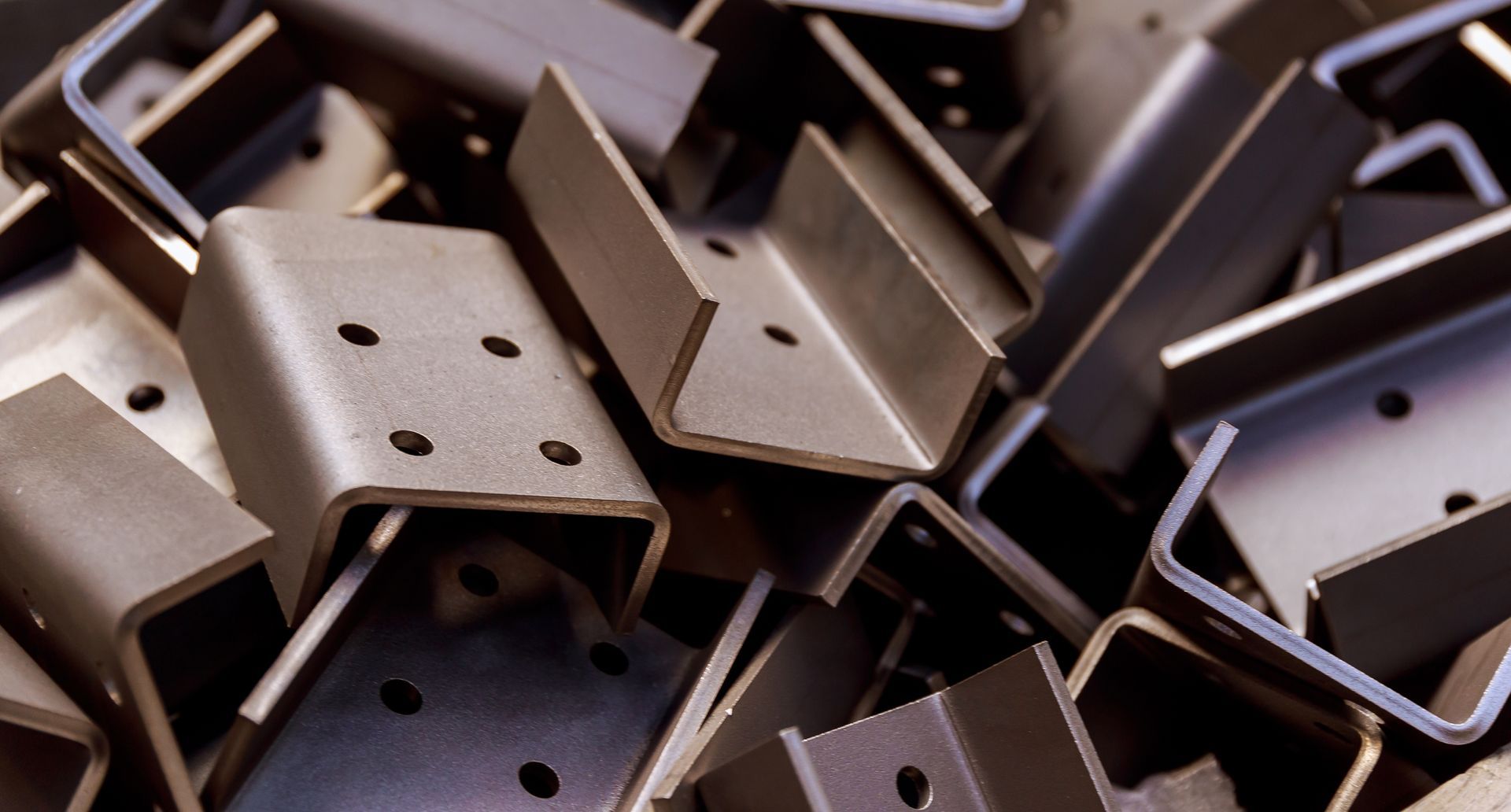 A pile of metal pieces with holes in them