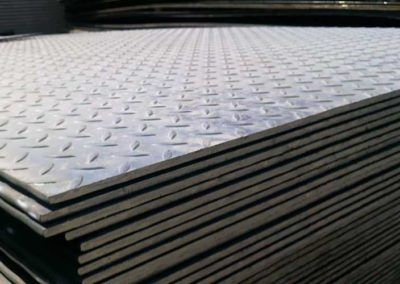A stack of stainless steel checkered plates sitting on top of each other.