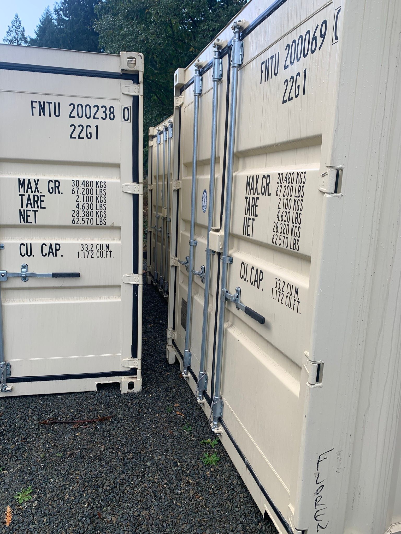 A row of shipping containers are lined up next to each other