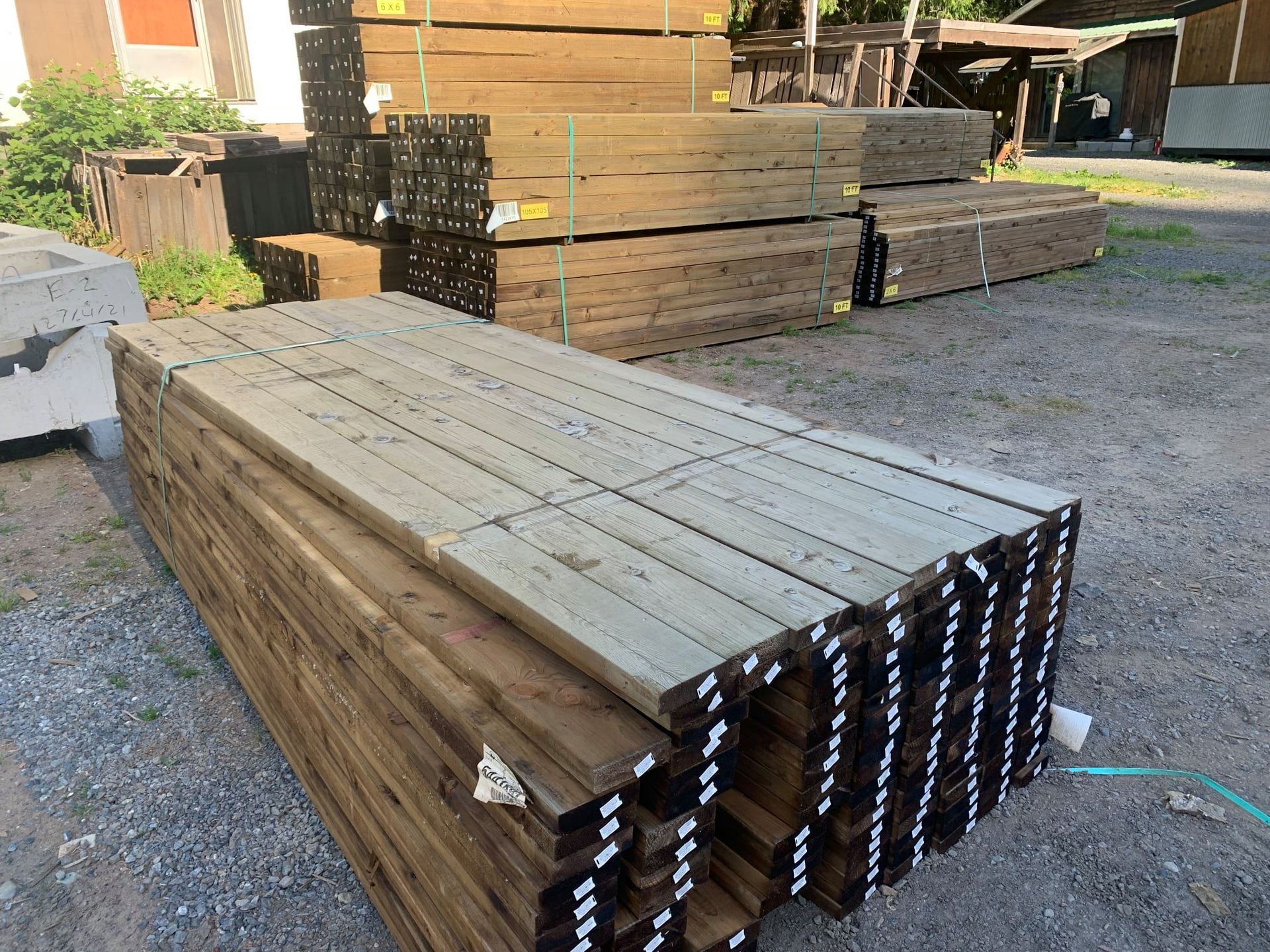 A stack of wooden boards sitting on top of each other in a yard.