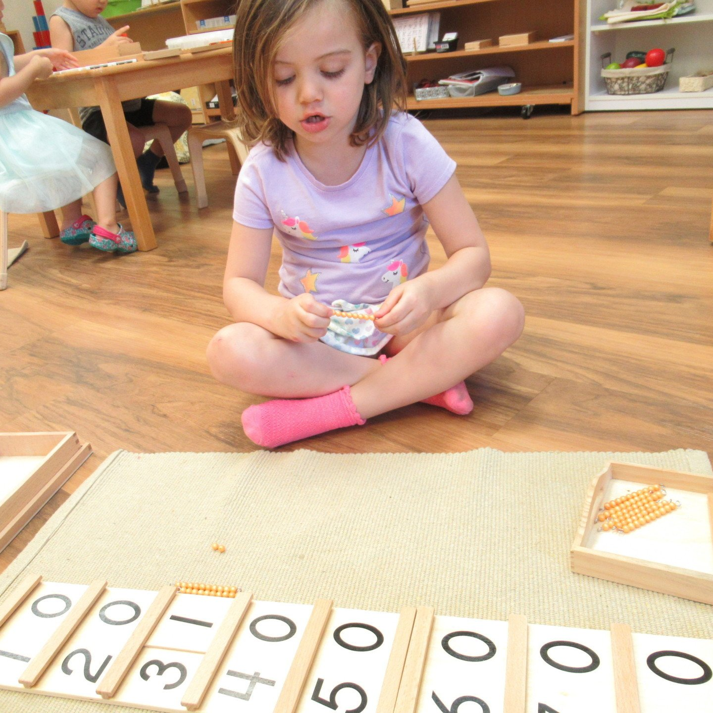 Child working with Montessori materials