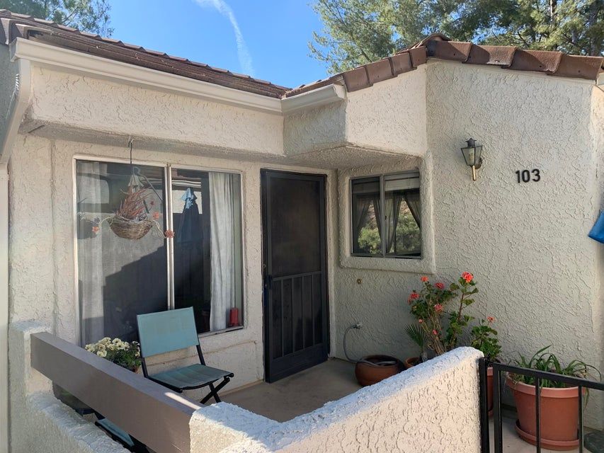 A small stucco house entryway labeled 