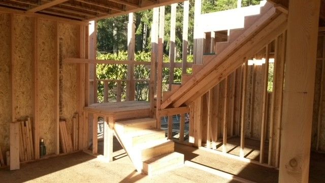 A wooden staircase in a house under construction