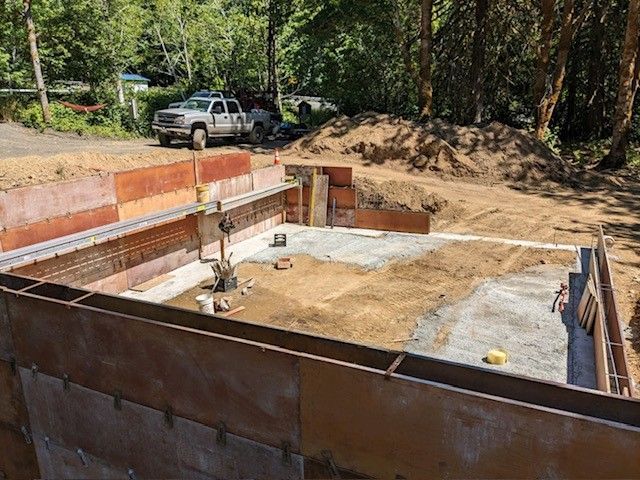 A construction site with a truck parked in the background.