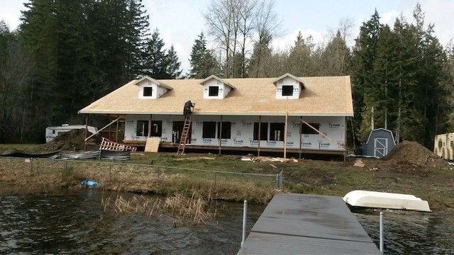 A house is being built next to a body of water