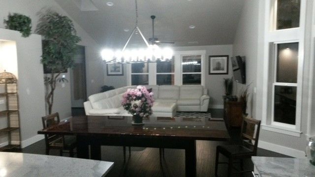 A living room with a sectional couch and a table