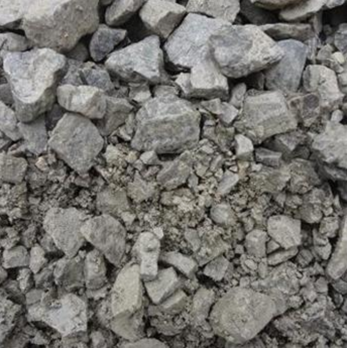 A close-up view of crushed gray limestone rock, showing a mix of large angular stones and fine gravel.