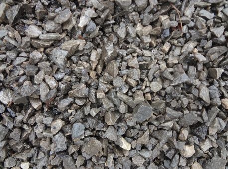 A close-up view of crushed gray stone, gravel, and rock fragments filling the frame.