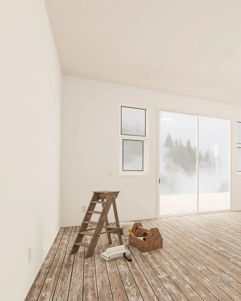 Interior room with ladder, toolbox, and window overlooking foggy trees.