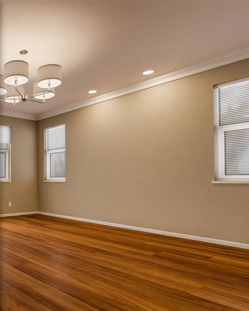 Empty room with wood floor, beige walls, and three windows with white blinds.