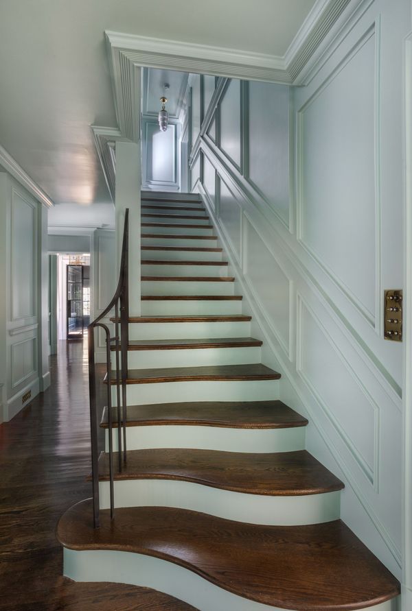 A set of stairs leading up to a hallway in a house.