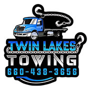 The logo for twin lakes towing shows a blue tow truck with hooks attached to it.