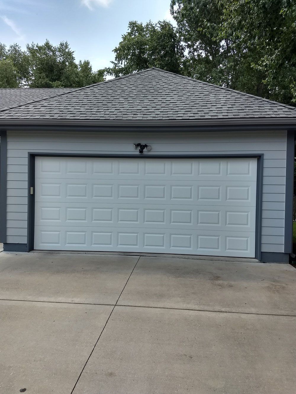 before and after picture of broken garage door being fixed