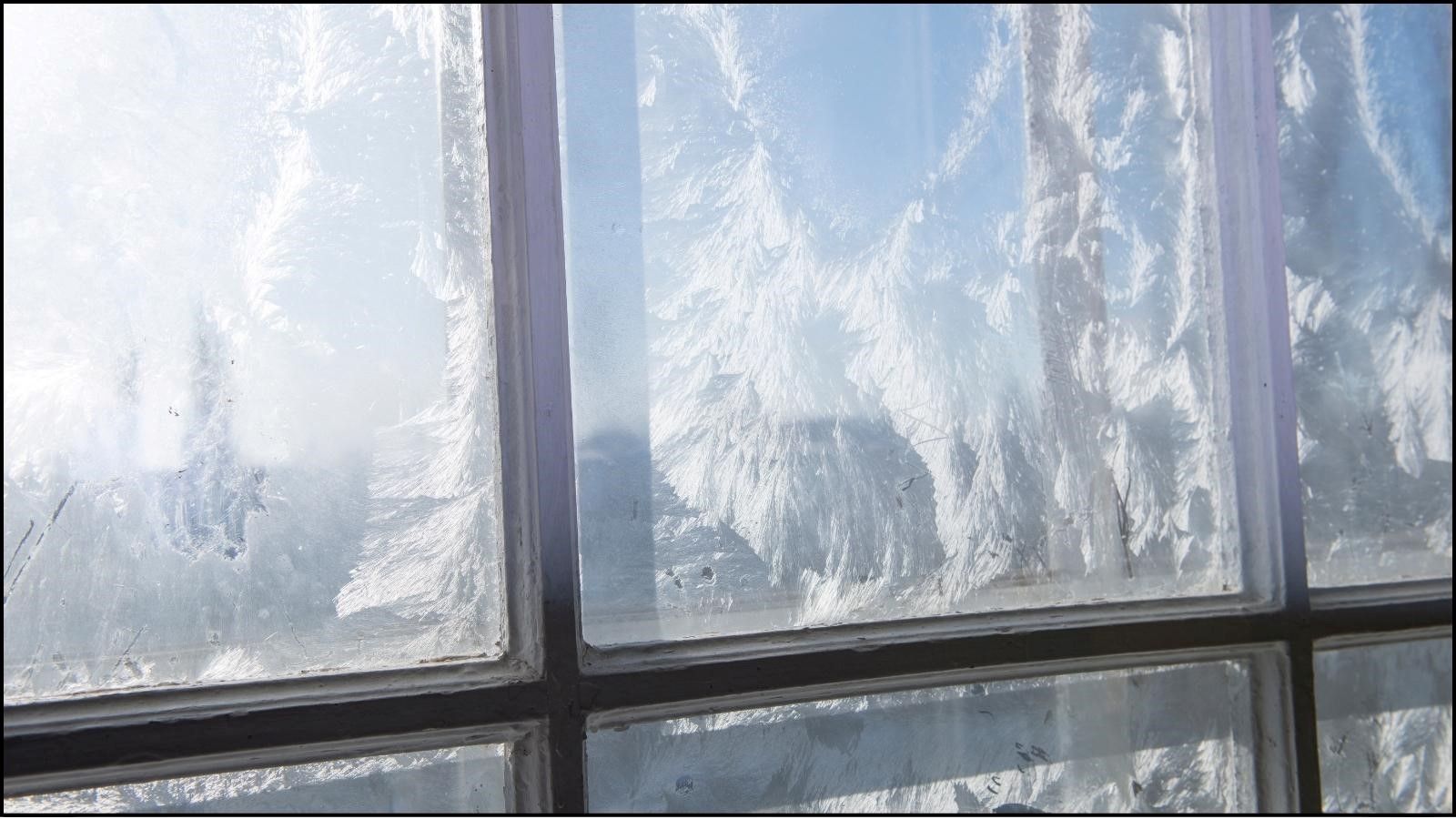 A close up of a window with frost on it.