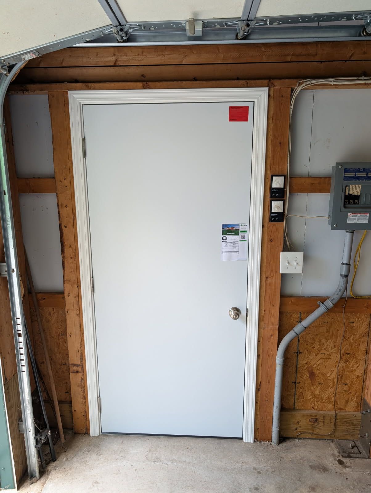 light grey entry door to home with decorative glass panels