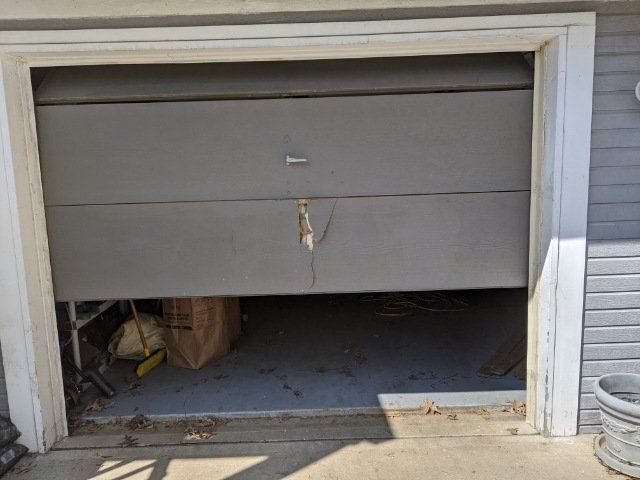 before picture of broken garage door panel