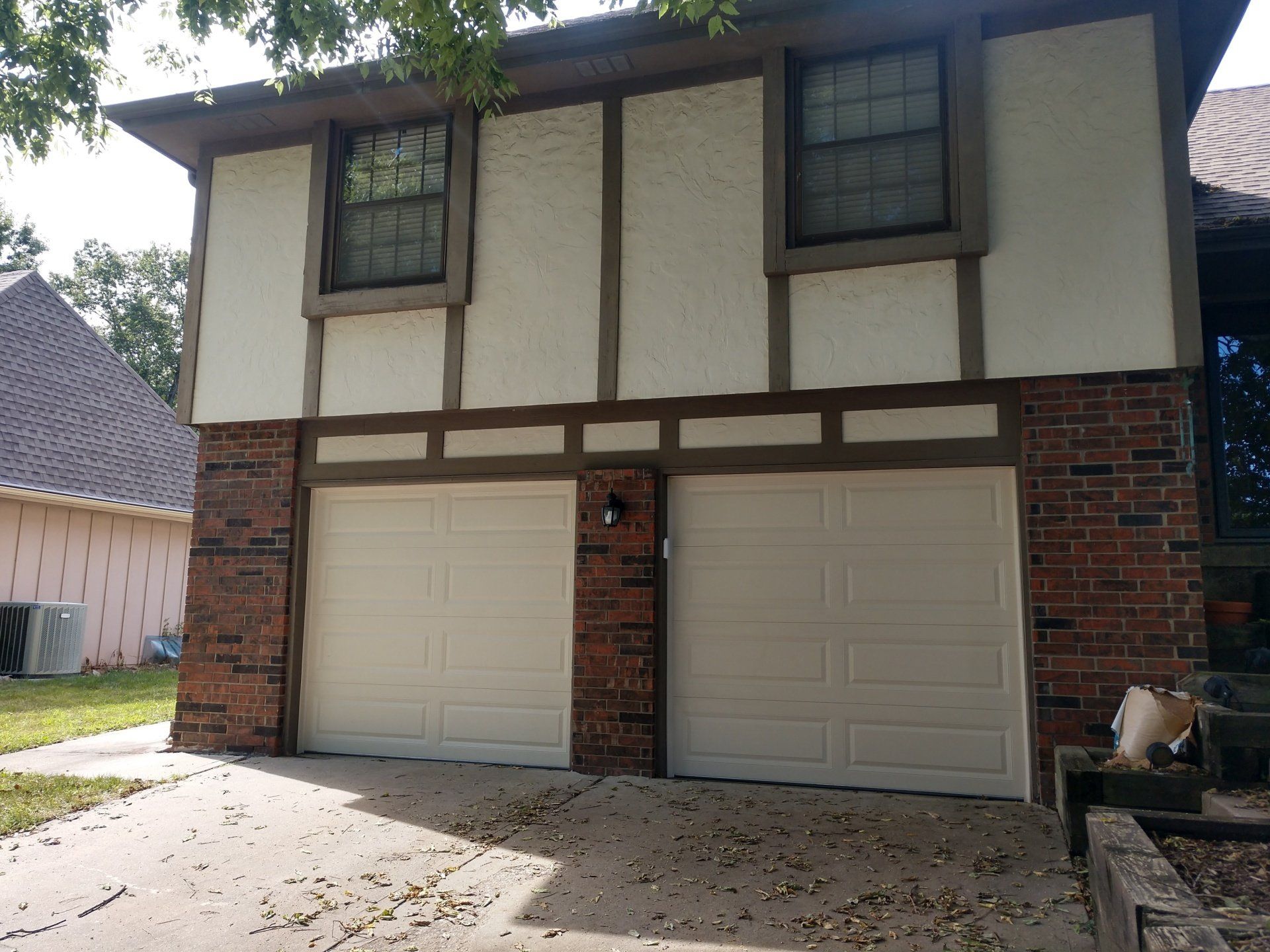 before and after picture of new garage door on an old home