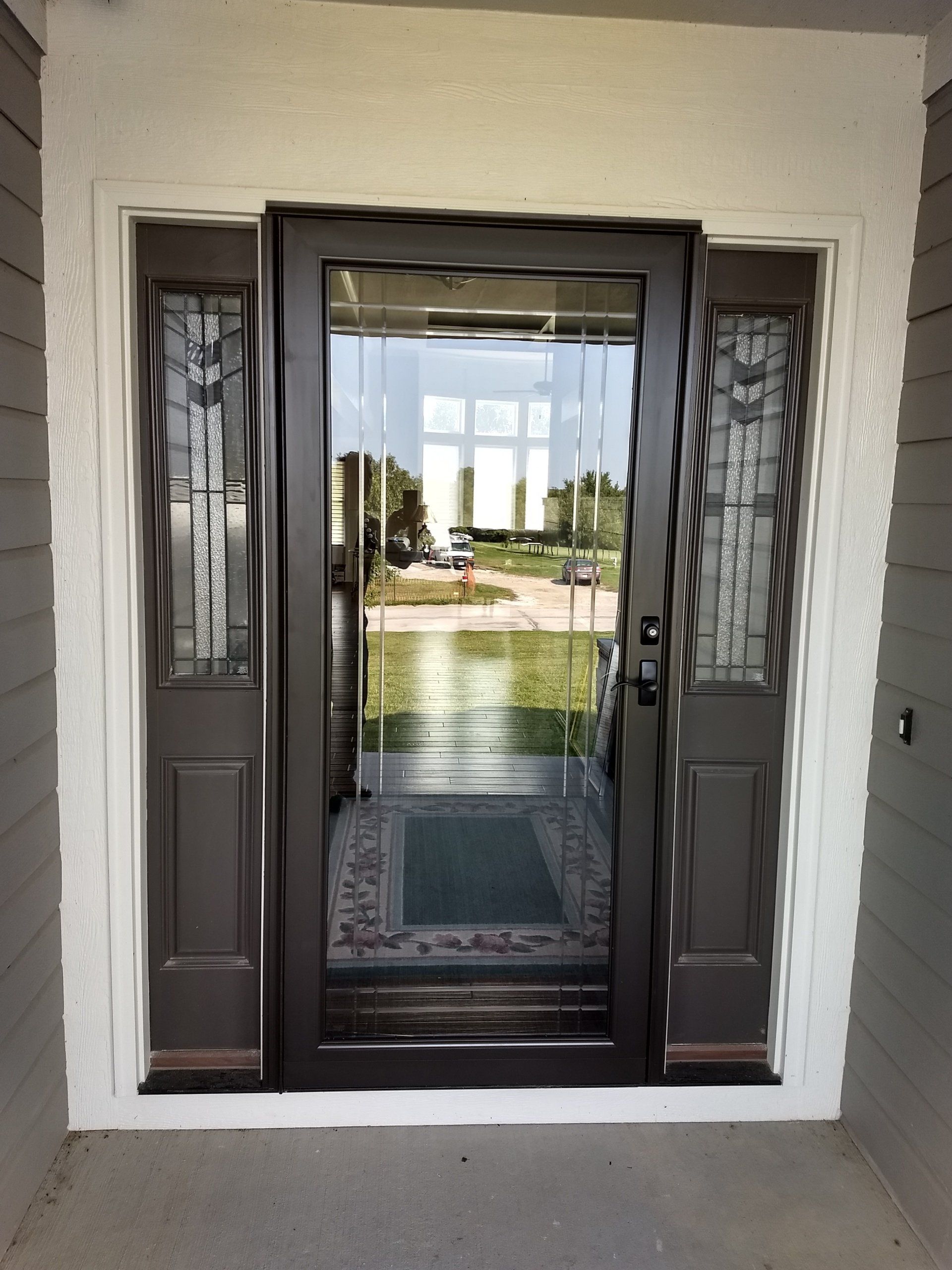 entry door to front of home with storm door