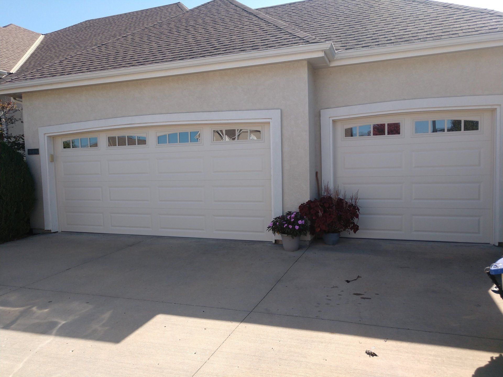 before and after picture of garage door install on home