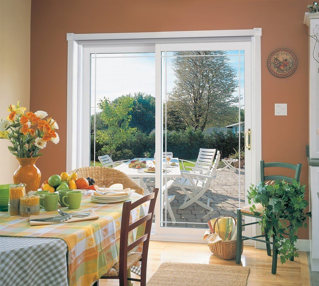 Sliding glass patio door opens to a backyard patio