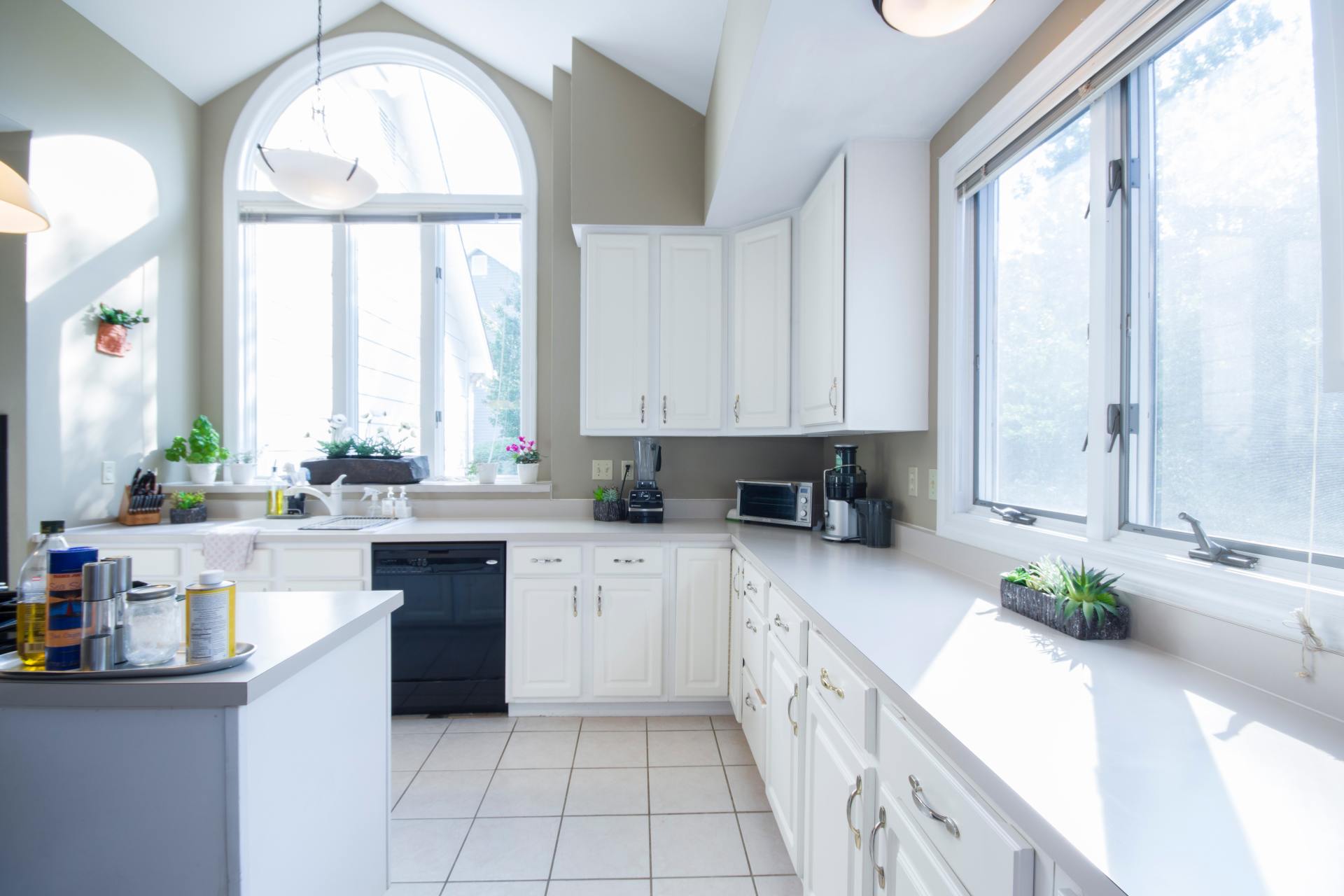 Empty kitchen with white wooden cabinet and aluminum window with lock ledges
