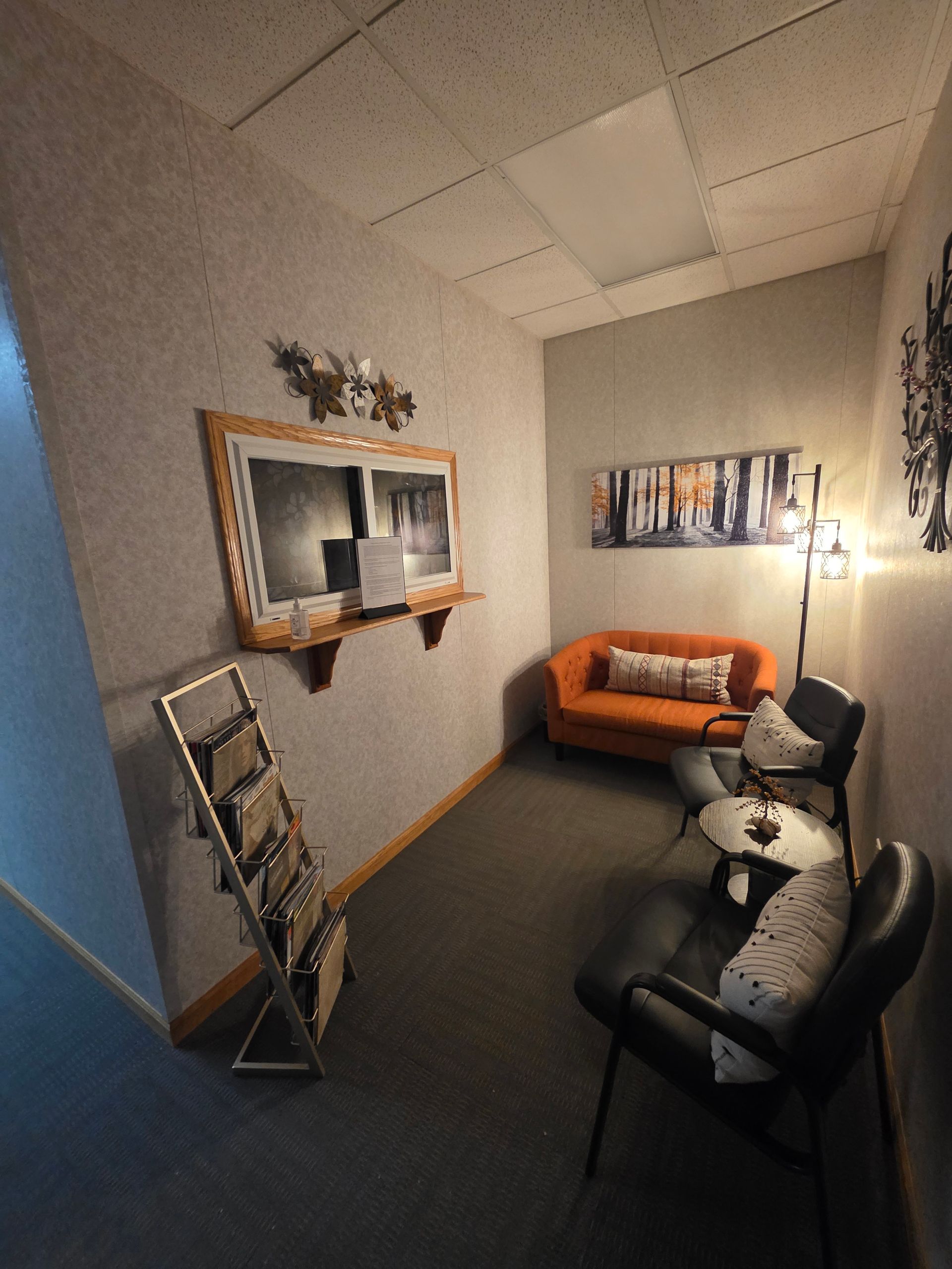 Woman and man in conversation, seated in a well-lit room. Man gestures while holding a tablet. Woman and man in conversation, seated in a well-lit room. Man gestures while holding a tablet.