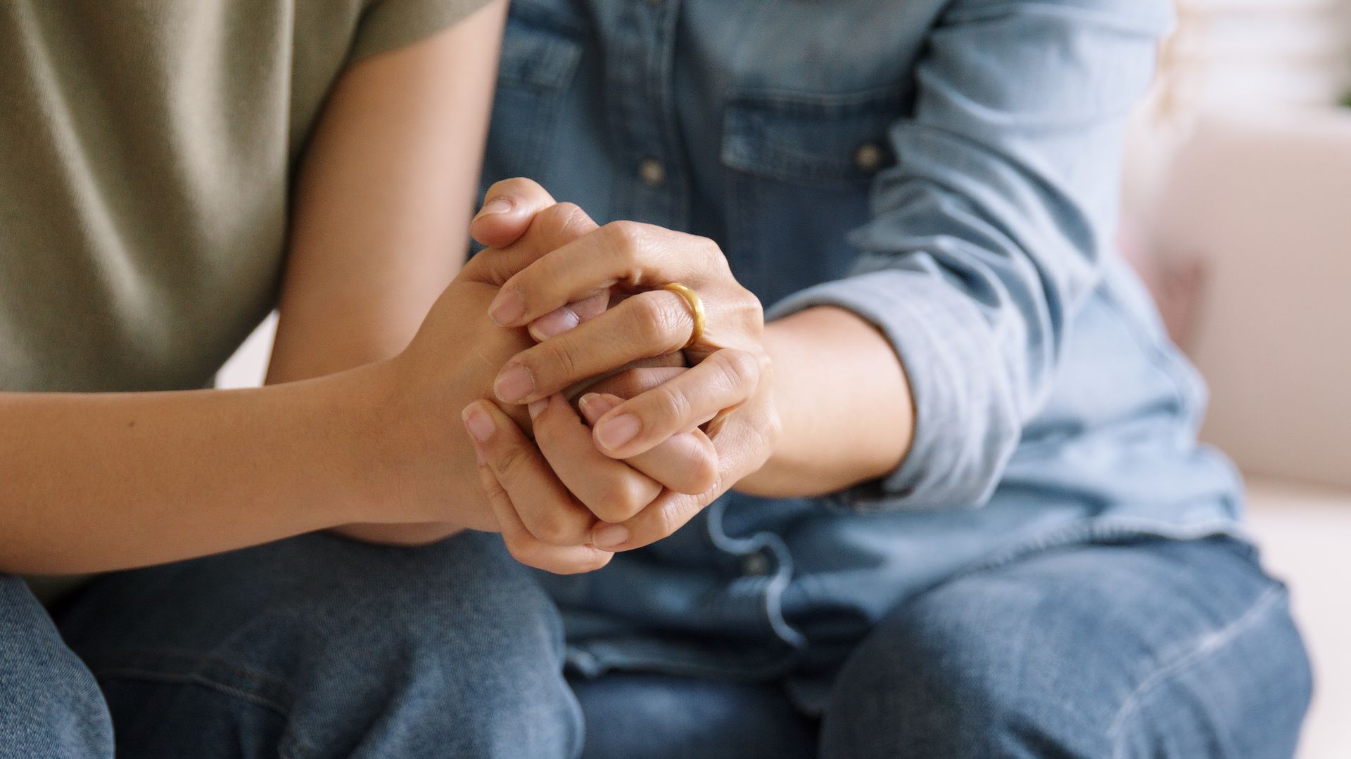 Hands of several people piled on top of each other in a symbol of teamwork and unity. Hands of several people piled on top of each other in a symbol of teamwork and unity.