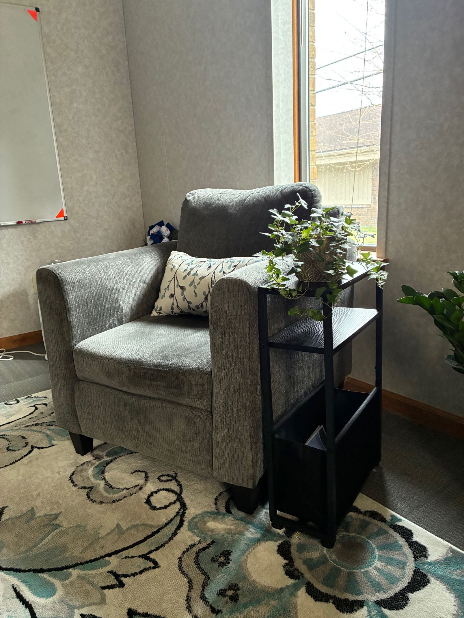 Person in green shirt and jeans holding hands with person holding clipboard, in an office setting. Person in green shirt and jeans holding hands with person holding clipboard, in an office setting.