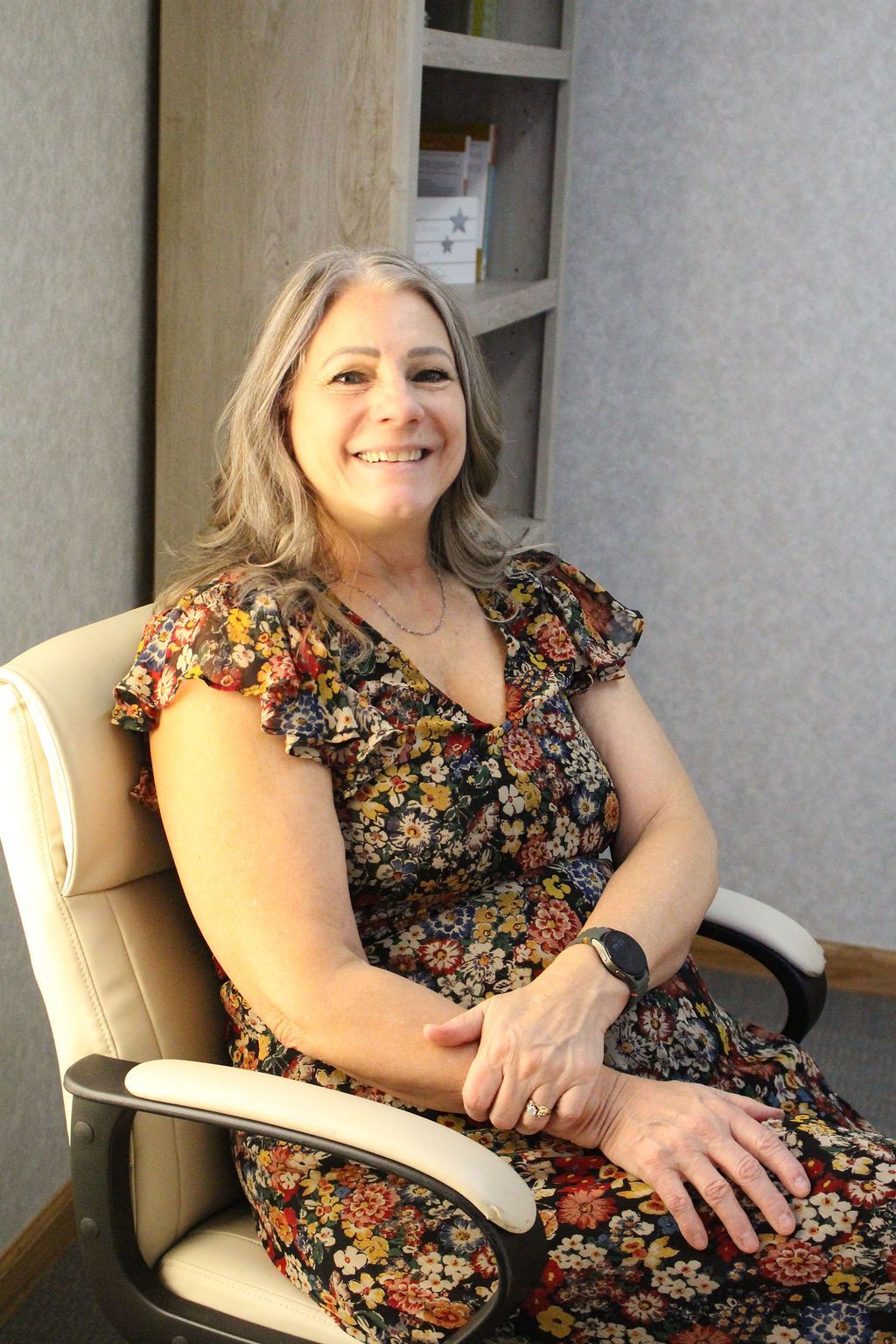 Couple holding hands during therapy session; therapist taking notes.