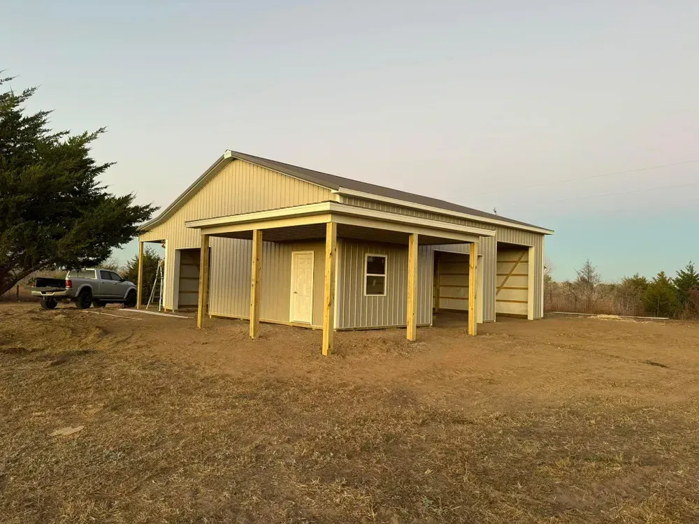 A garage with a porch and a truck parked in front of it