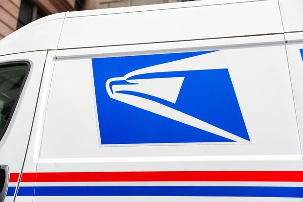 Blue USPS logo on a white postal van, with red and blue stripes.
